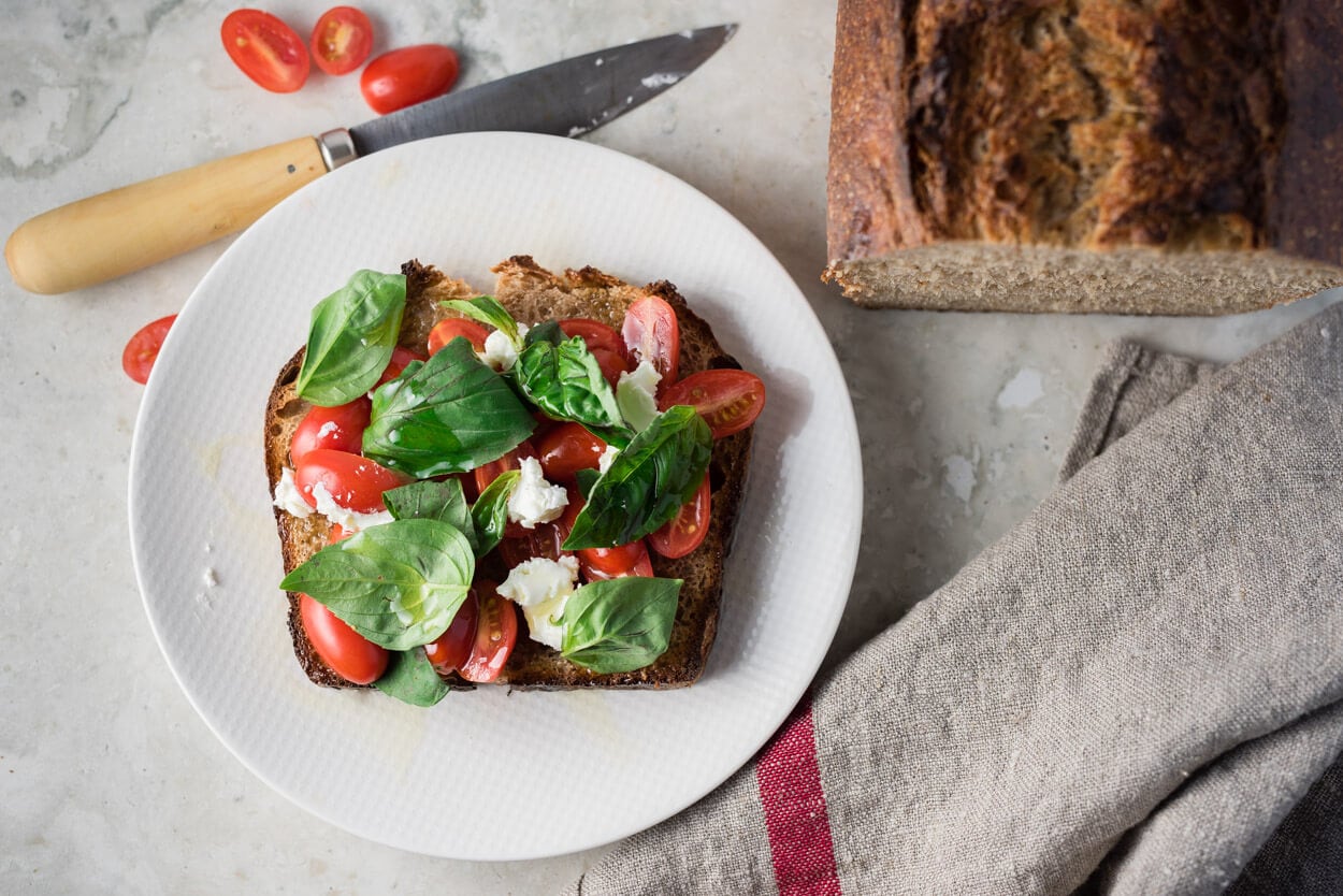 tomato, goat cheese, basil and EVOO on sourdough sandwich bread
