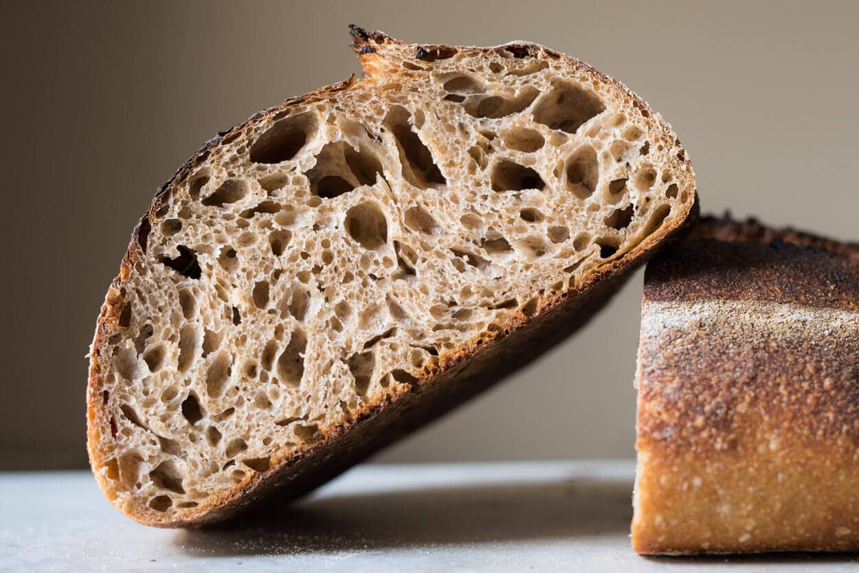 Sourdough bread slicing in industrial bread slicing machine Stock