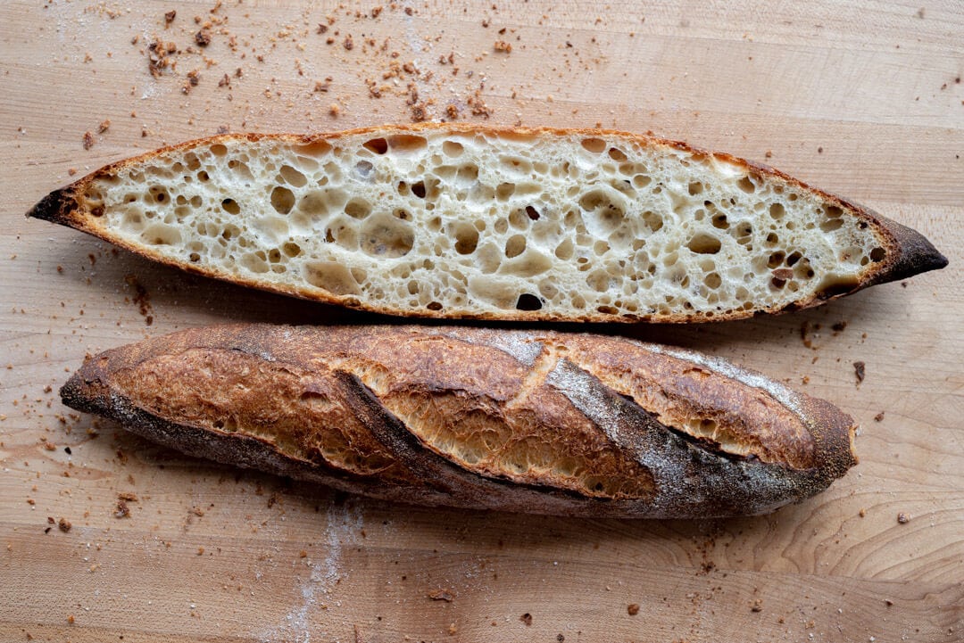 Baguette, European style bread on black wood table in morning time