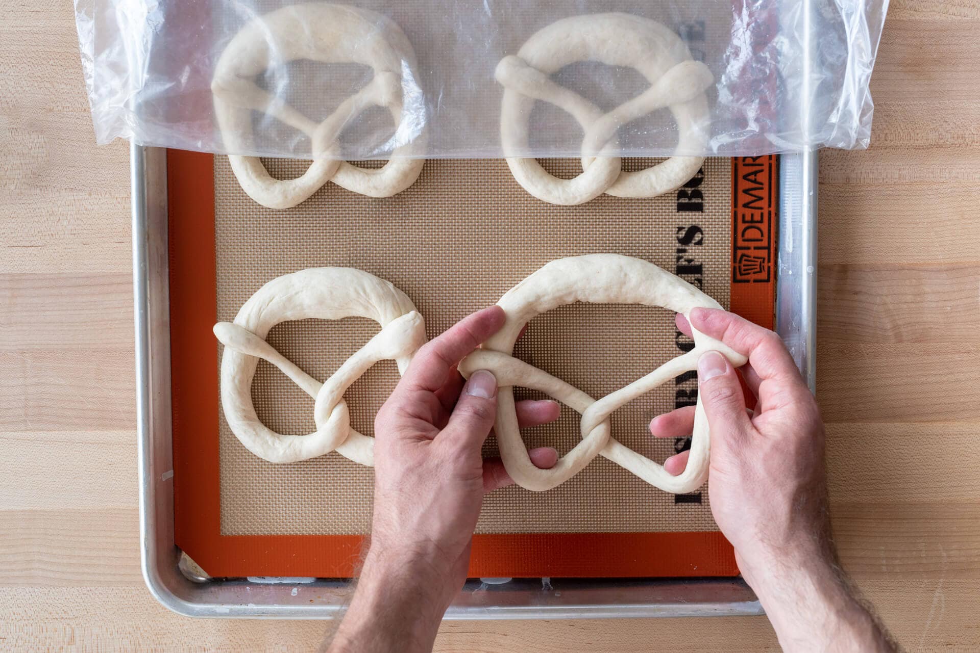 soft sourdough pretzels shaped and ready for proofing