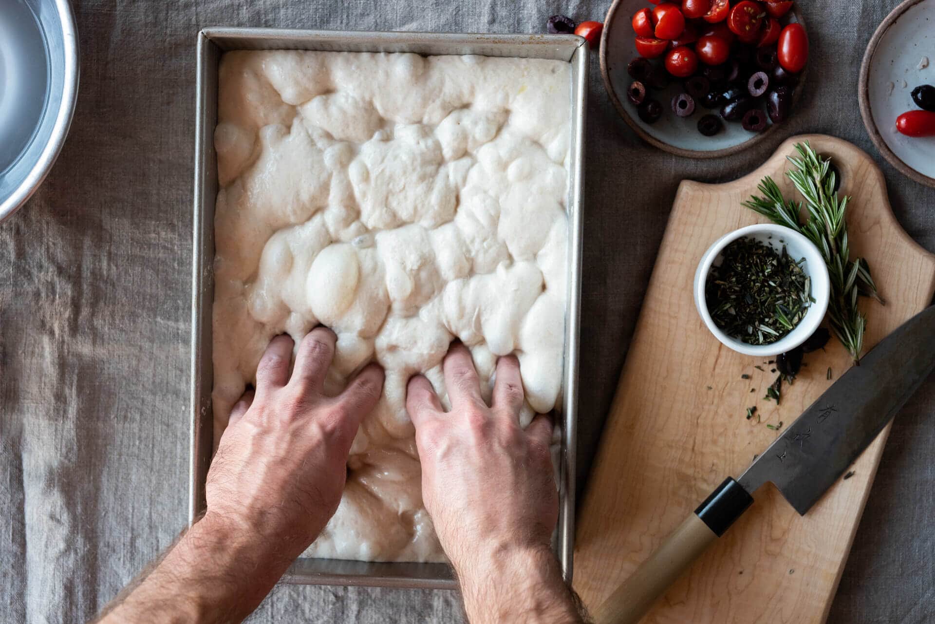 Dimpling focaccia dough