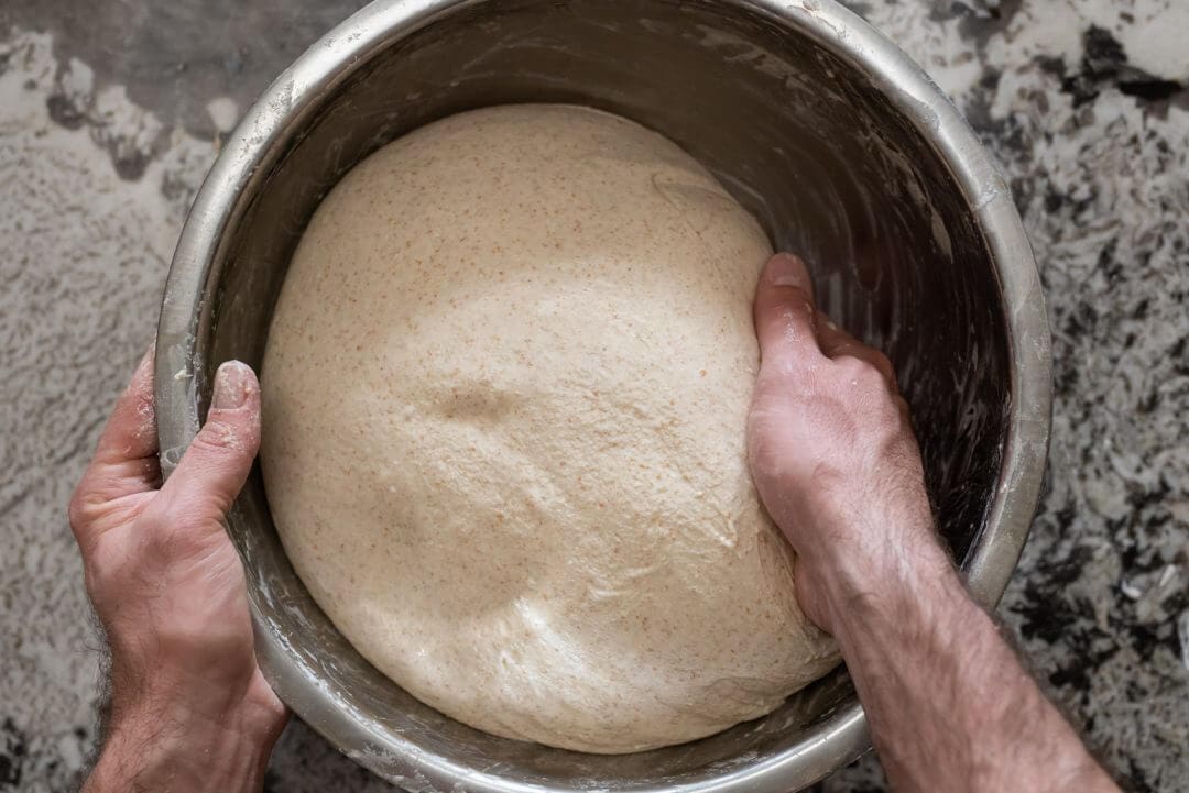 Hand mixing spelt, rye, and whole wheat dough