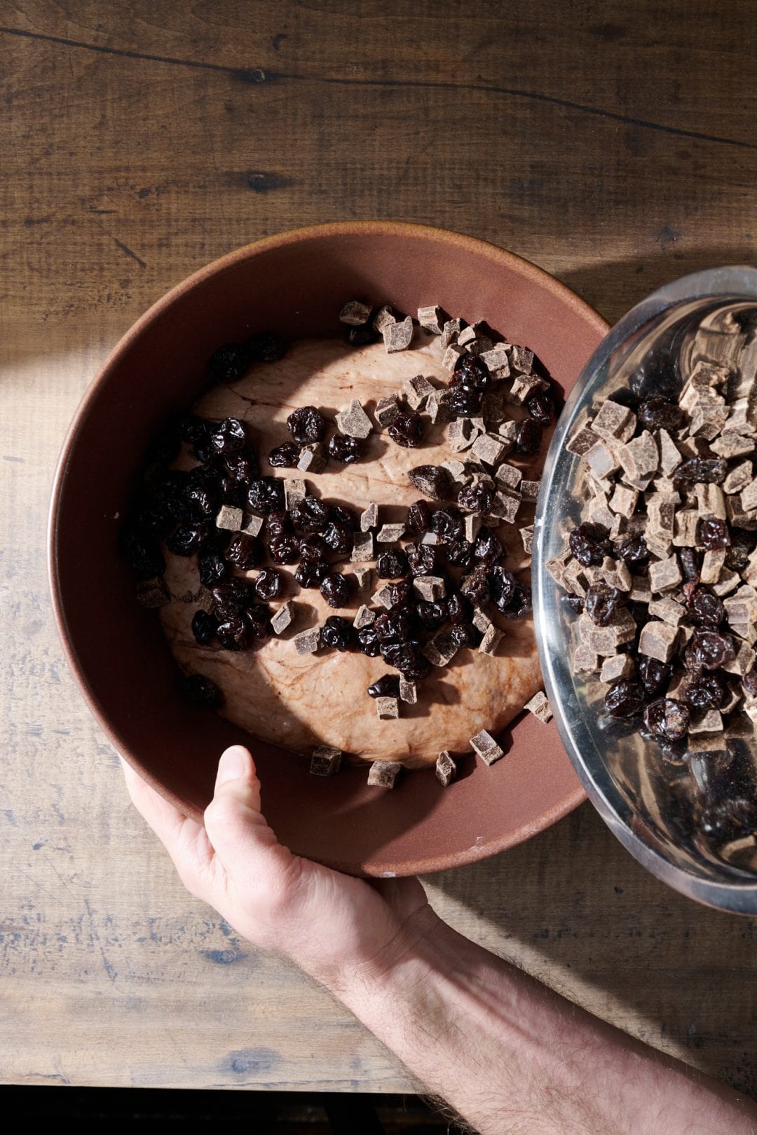 Adding chocolate and cherries to sourdough bread dough