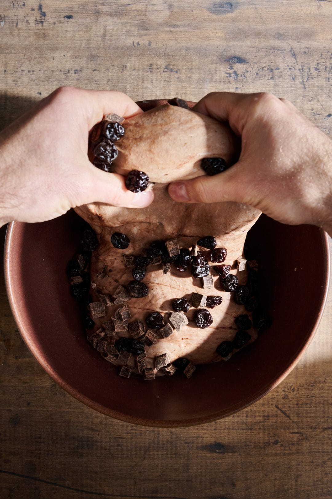 Adding chocolate and cherries to sourdough bread dough