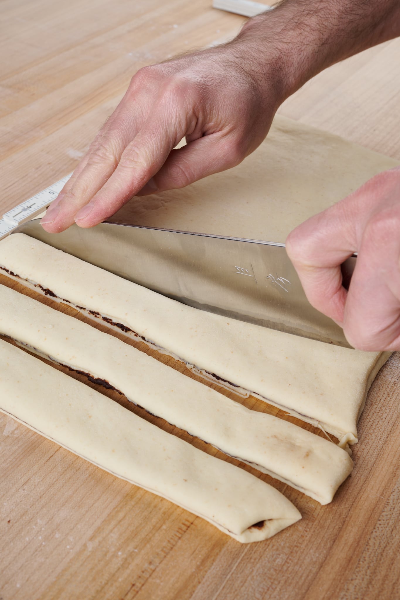 Cutting, twisting, and knotting dough