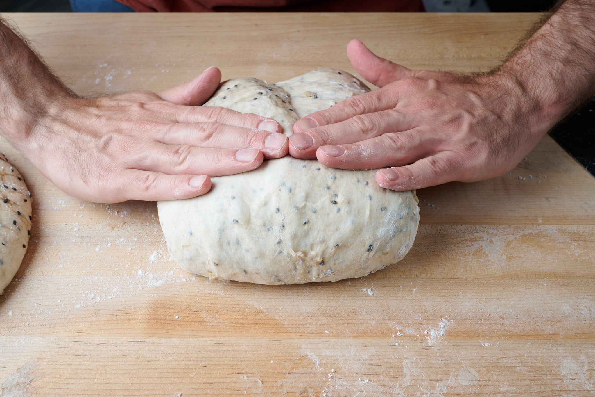 Shaping brown rice and sesame sourdough bread dough