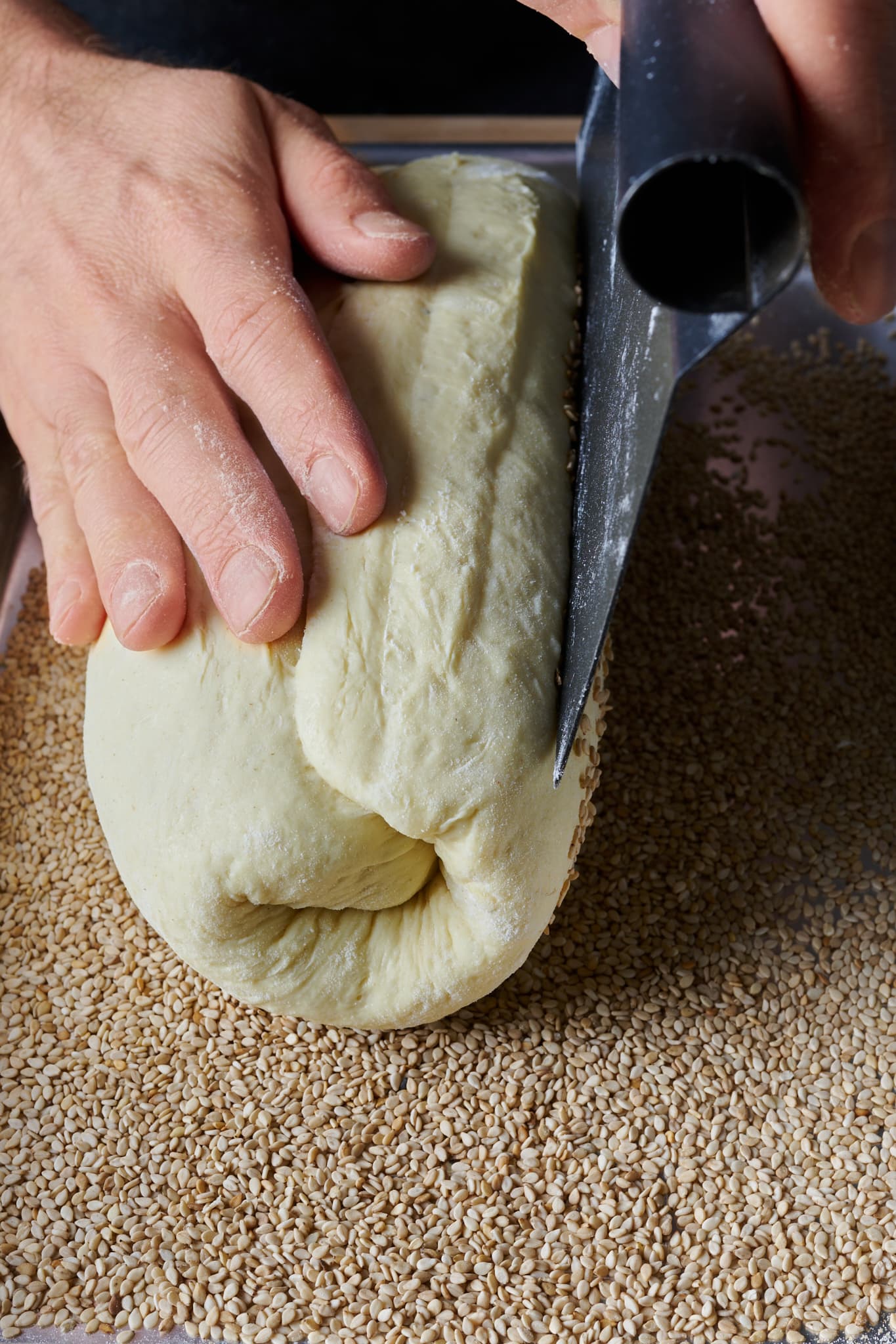 Topping Pane Siciliano bread dough with white sesame seeds.