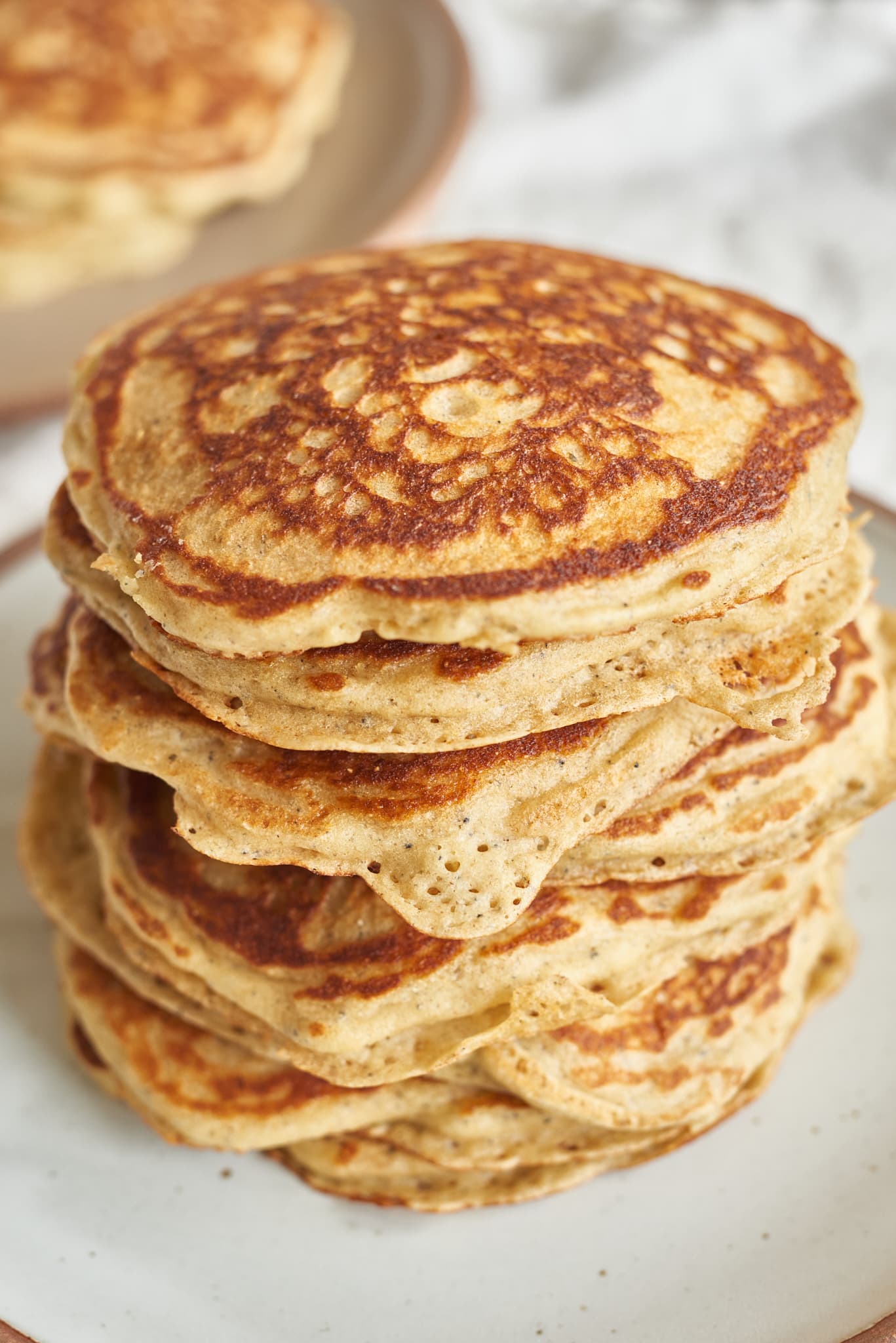 A stack of sourdough starter discard pancakes with cornmeal. 