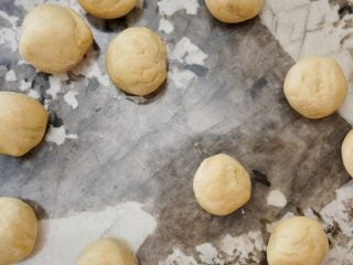 Rolling sourdough tortilla dough.