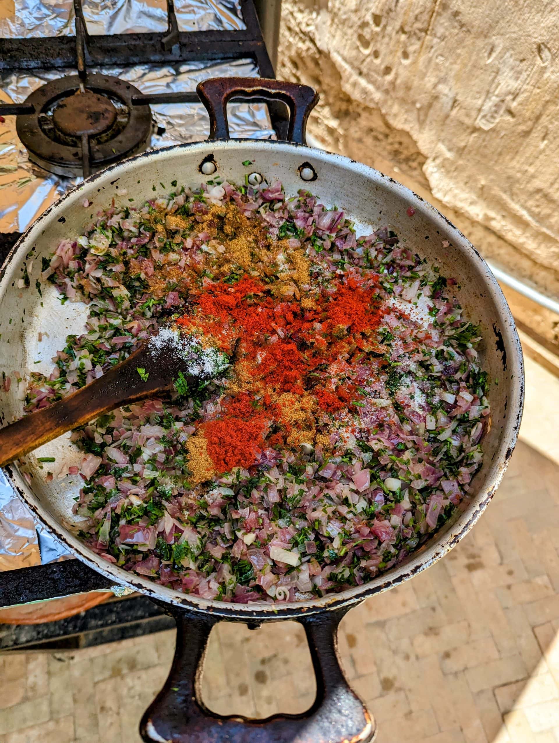 Preparing fried red onions and paprika for filling m’lawi.