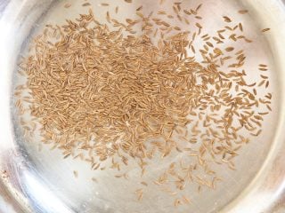 Toasting caraway seeds for light deli rye bread.