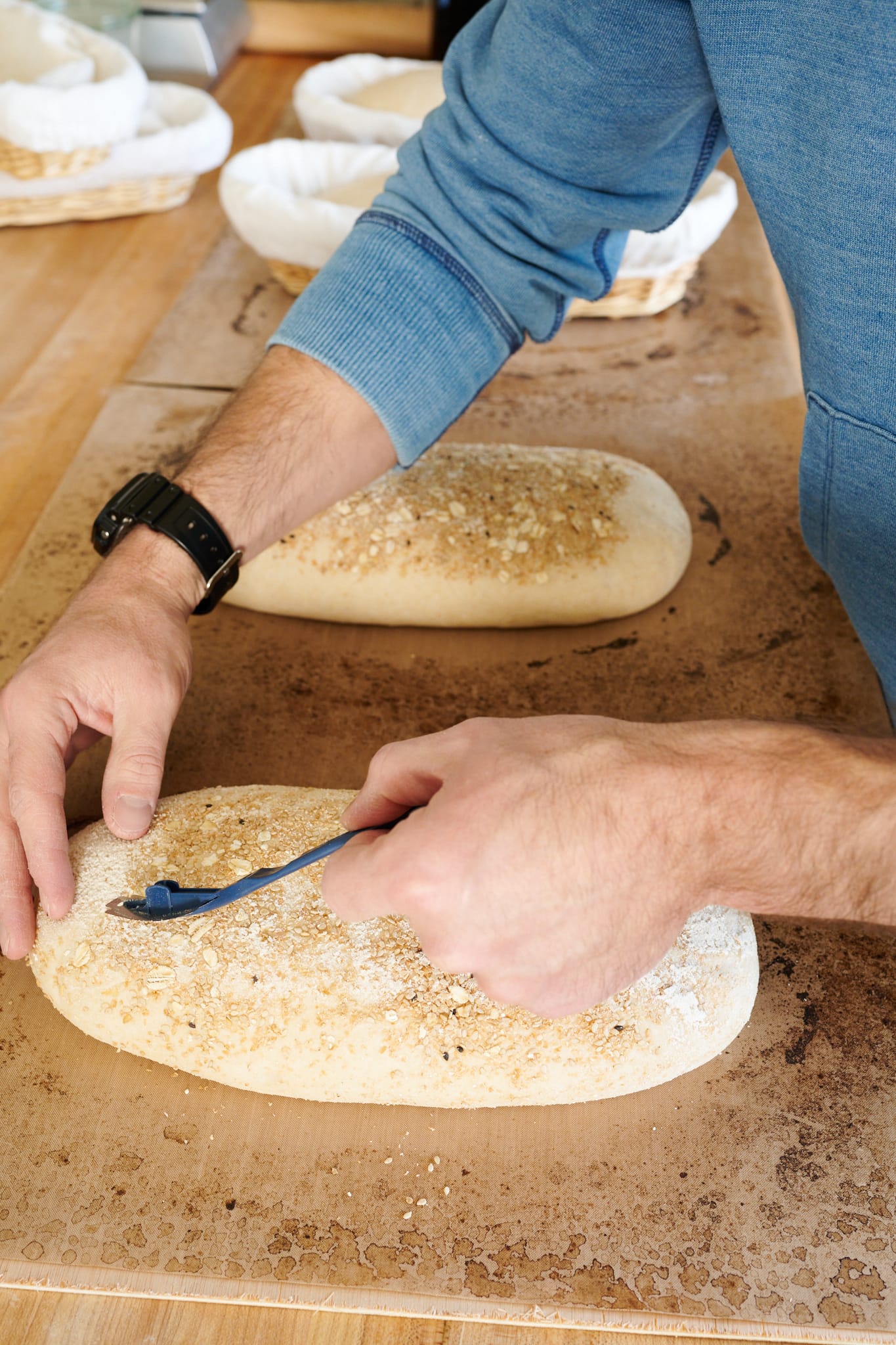 Scoring bread dough before baking in the RackMaster oven.