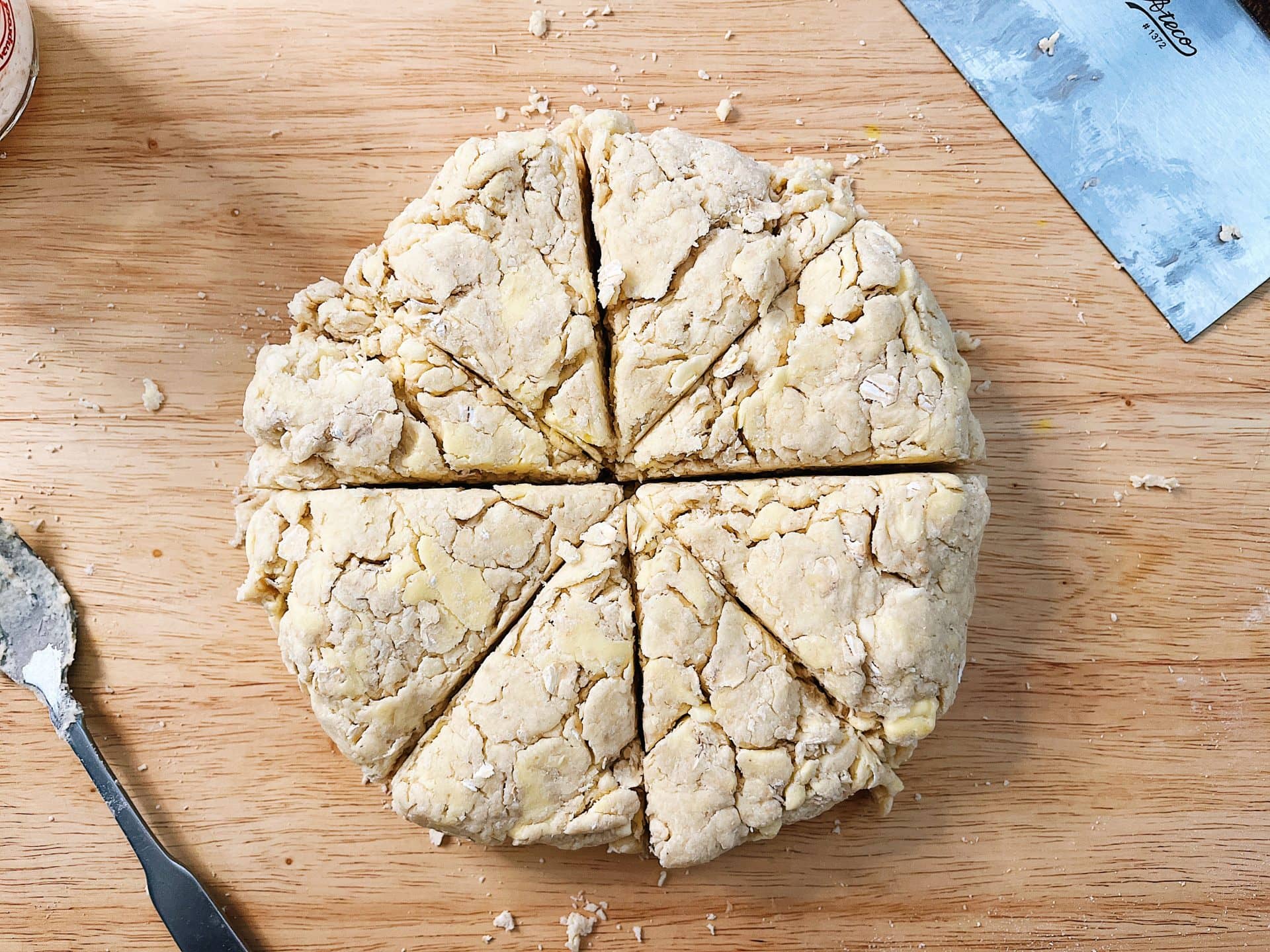 Starter discard scone dough formed into a 2-inch tall disc.