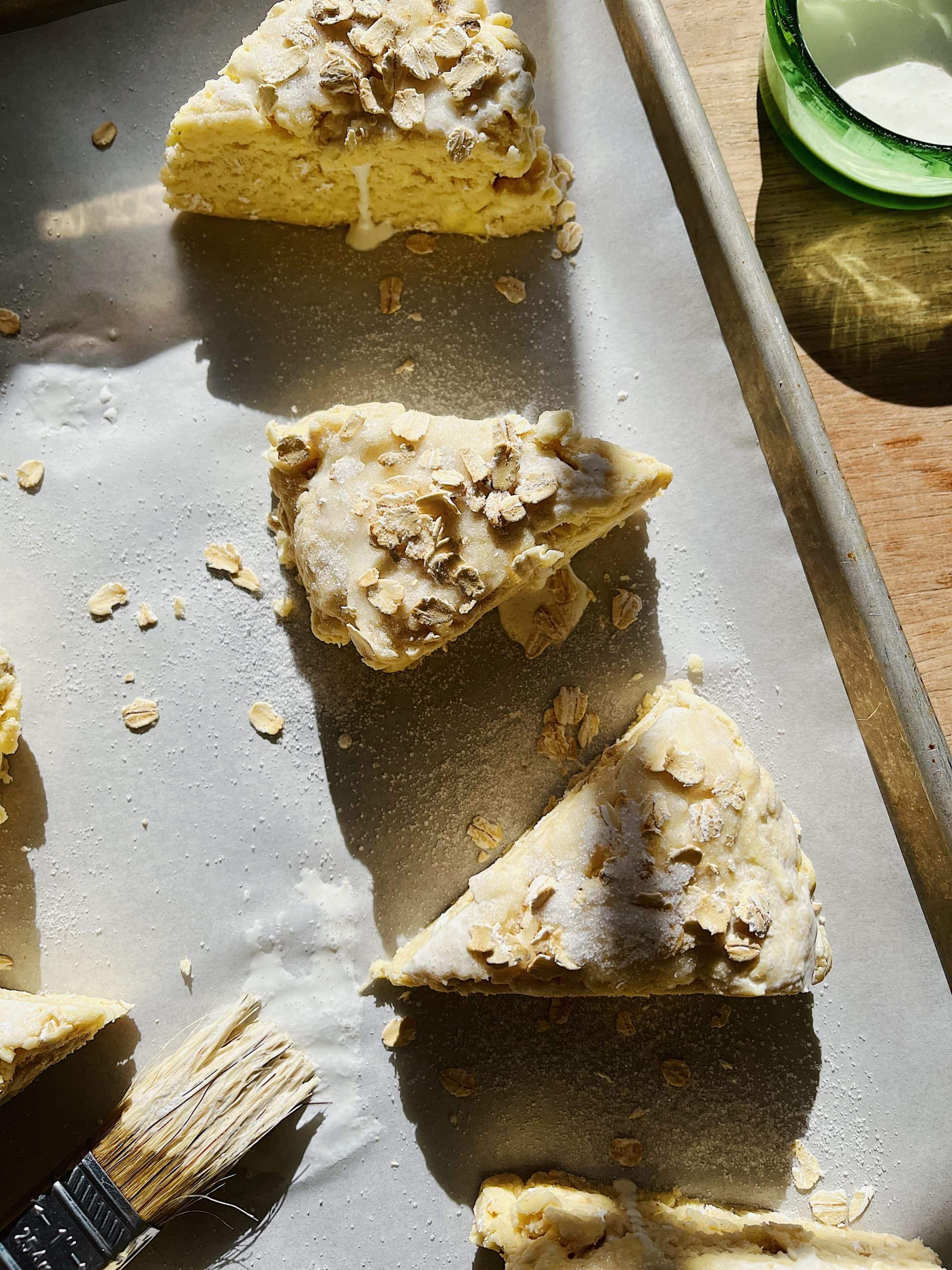 Sourdough starter discard scones brushed with heavy cream and topped with oats and sugar.