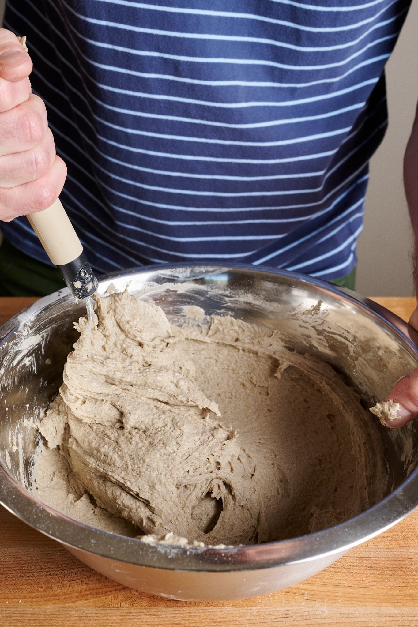 Mixing rye dough with a dough whisk.