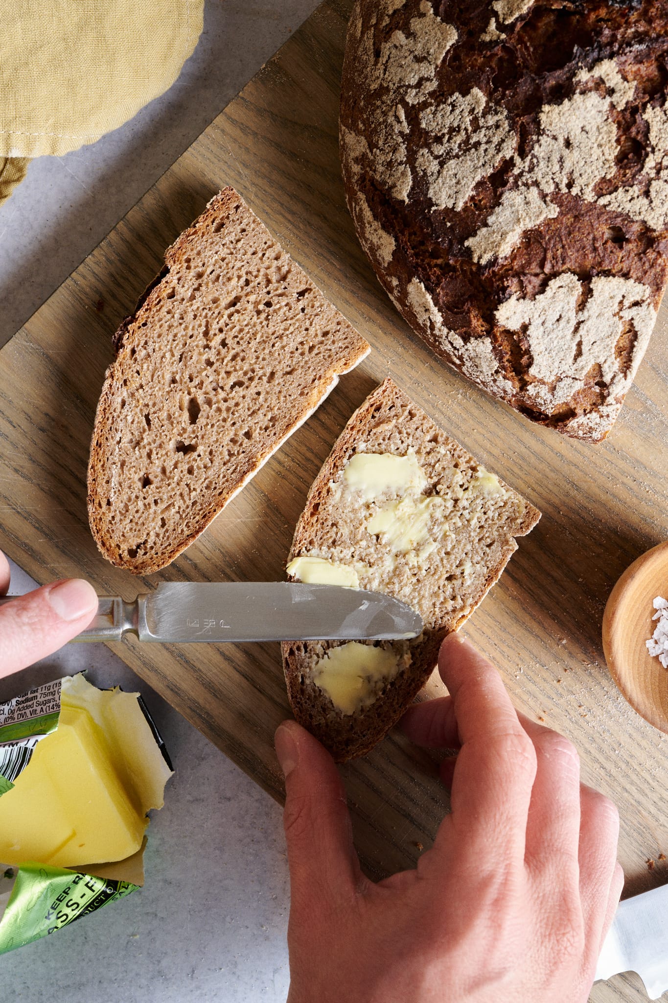 Sourdough rye bread sliced with butter.