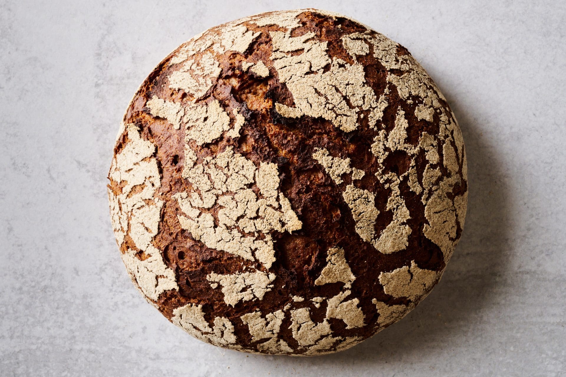 Sourdough 90-rye bread with cracked crust.