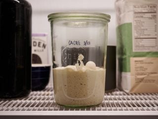 Sourdough starter cache in refrigerator.