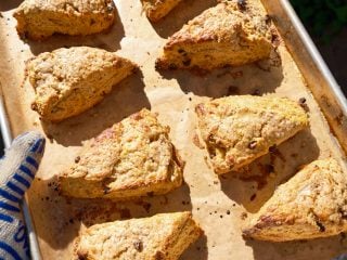 Baked sourdough discard pumpkin scones on a baking sheet.