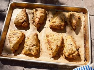 Sourdough pumpkin scones on a baking sheet.