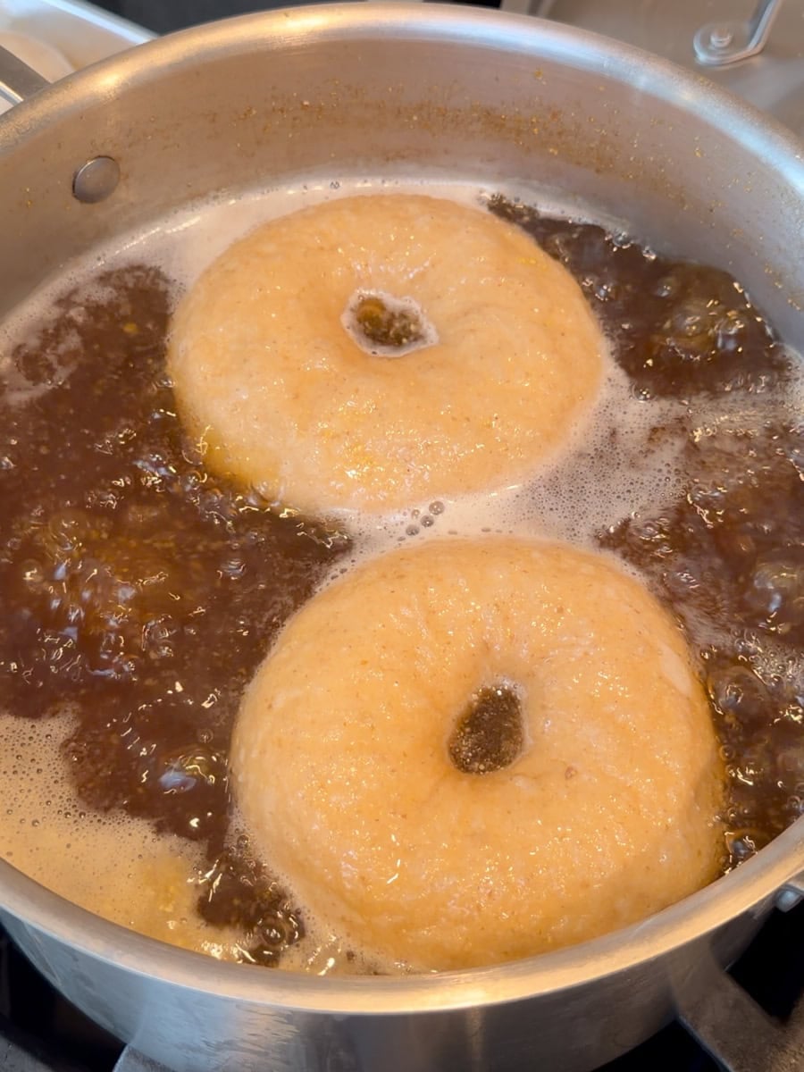 Boiling sourdough bagel dough.